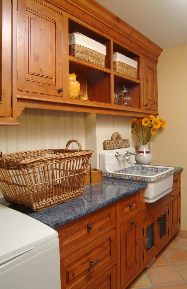 Inspiration for a medium sized traditional single-wall separated utility room in San Francisco with an utility sink, raised-panel cabinets, dark wood cabinets, granite worktops, beige walls, terracotta flooring, a side by side washer and dryer and brown floors.