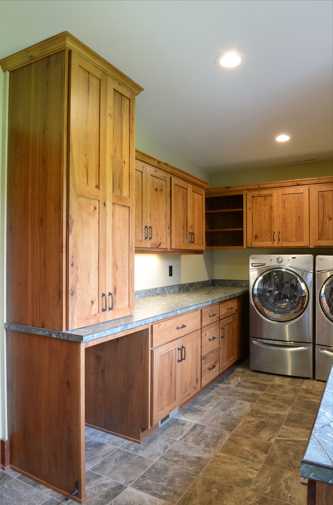 Dedicated laundry room - mid-sized traditional u-shaped dedicated laundry room idea in Other with a single-bowl sink, shaker cabinets, medium tone wood cabinets, laminate countertops, a side-by-side washer/dryer and green walls
