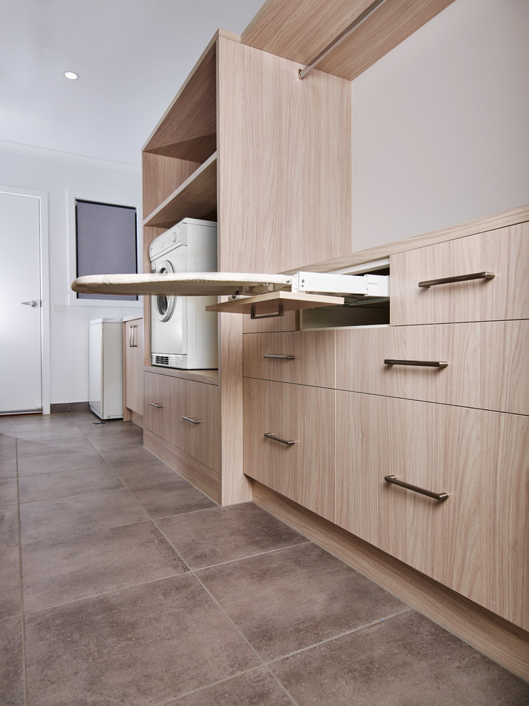 Design ideas for a large contemporary single-wall separated utility room in Other with a built-in sink, flat-panel cabinets, light wood cabinets, laminate countertops, white walls, ceramic flooring, grey floors and multicoloured worktops.