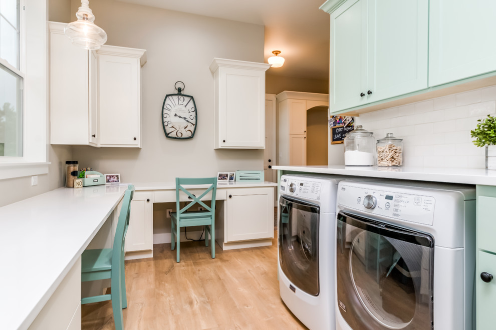 This is an example of a medium sized country galley utility room in Denver with a submerged sink, shaker cabinets, white cabinets, composite countertops, beige walls, medium hardwood flooring, a side by side washer and dryer, brown floors and white worktops.