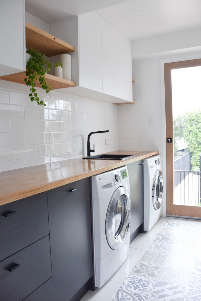 Design ideas for a medium sized modern utility room in Sunshine Coast with wood worktops.