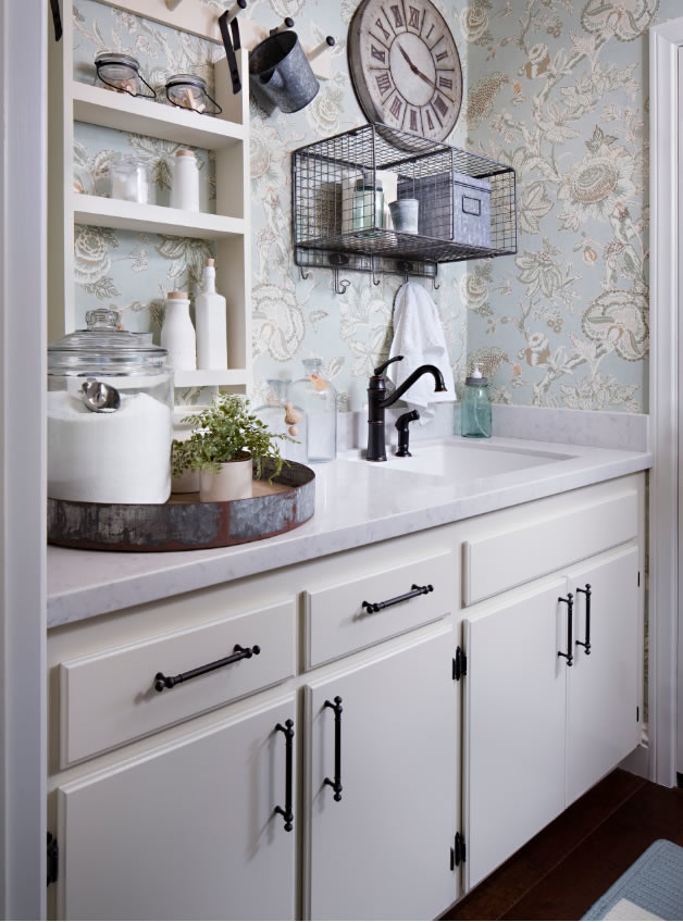 Design ideas for a small farmhouse galley utility room in San Diego with a submerged sink, white cabinets, quartz worktops, blue walls, dark hardwood flooring and flat-panel cabinets.