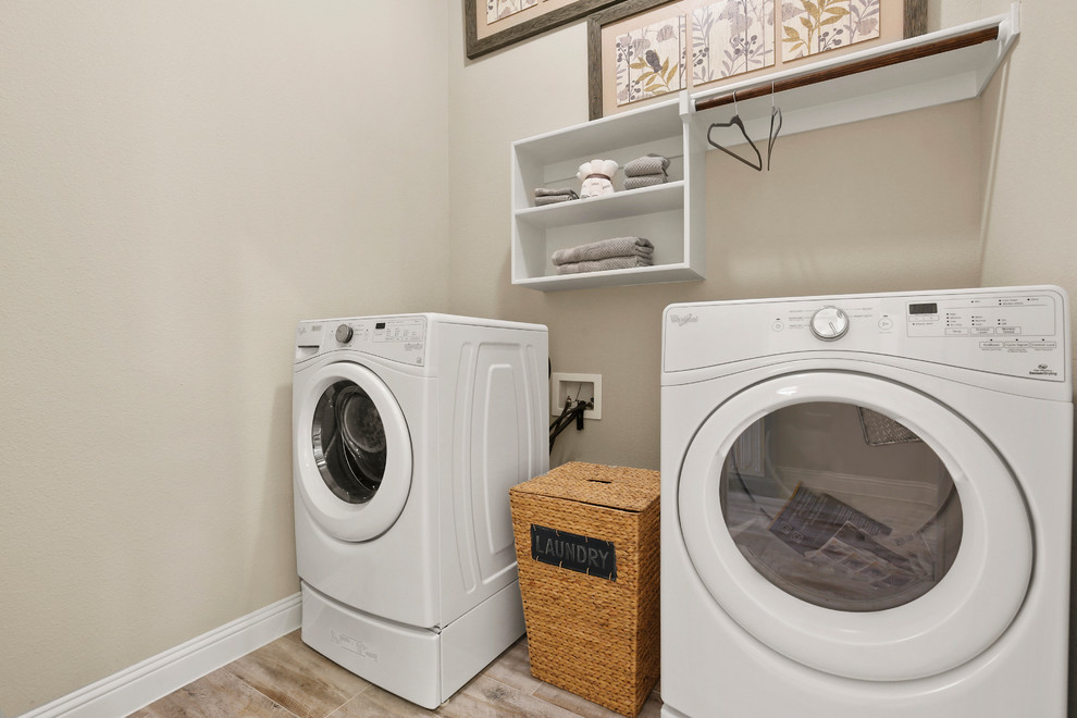Idéer för en mellanstor modern linjär tvättstuga enbart för tvätt, med öppna hyllor, vita skåp, beige väggar, klinkergolv i keramik, en tvättmaskin och torktumlare bredvid varandra och beiget golv