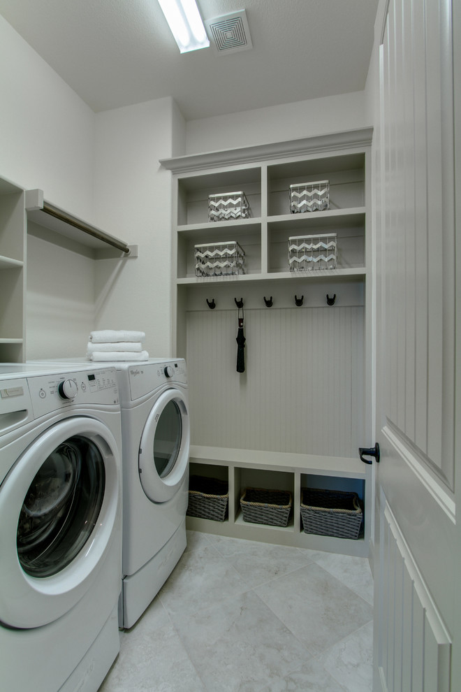 Example of a mid-sized single-wall porcelain tile utility room design in Dallas with open cabinets, white cabinets, beige walls and a side-by-side washer/dryer