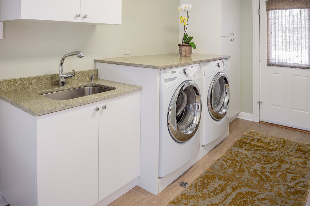 Mid-sized transitional single-wall porcelain tile dedicated laundry room photo in Chicago with an undermount sink, flat-panel cabinets, white cabinets, granite countertops, a side-by-side washer/dryer and gray walls