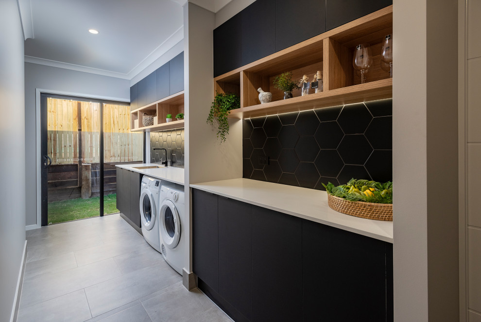 Design ideas for a contemporary utility room in Sunshine Coast with a built-in sink, grey walls, a side by side washer and dryer and grey floors.