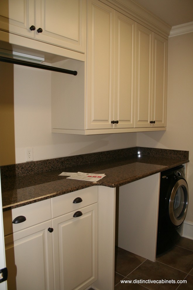 Example of a classic laundry room design in Charlotte with raised-panel cabinets and white cabinets