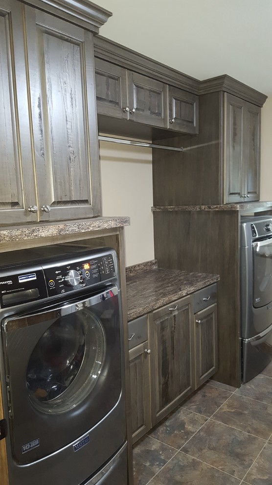 Mid-sized mountain style single-wall vinyl floor dedicated laundry room photo in Minneapolis with raised-panel cabinets, distressed cabinets, laminate countertops and beige walls