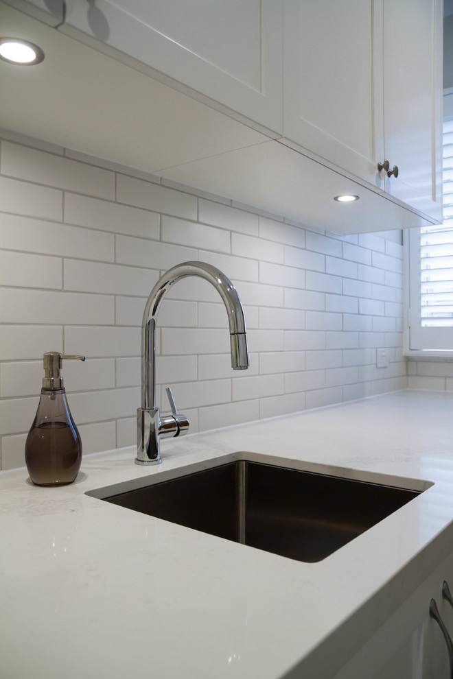 Inspiration for a medium sized classic galley utility room in Melbourne with a submerged sink, shaker cabinets, white cabinets, engineered stone countertops, porcelain flooring and a side by side washer and dryer.
