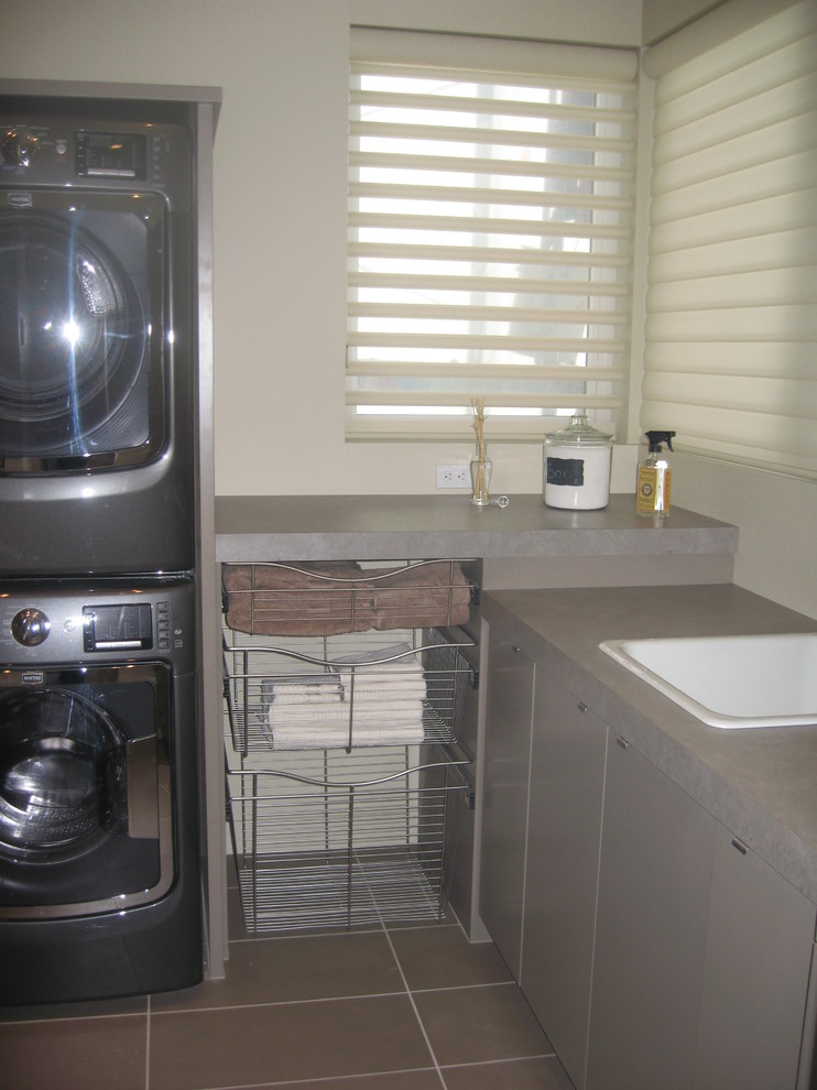 Example of a trendy laundry room design in Calgary