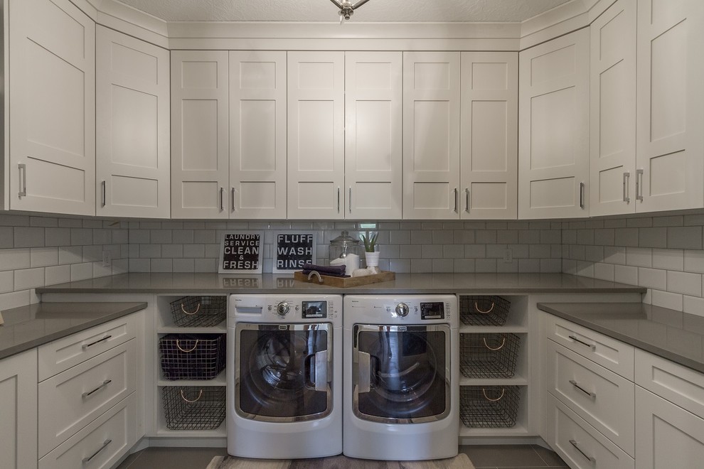 Large trendy u-shaped light wood floor dedicated laundry room photo in Salt Lake City with recessed-panel cabinets, white cabinets, quartz countertops, white walls and a side-by-side washer/dryer