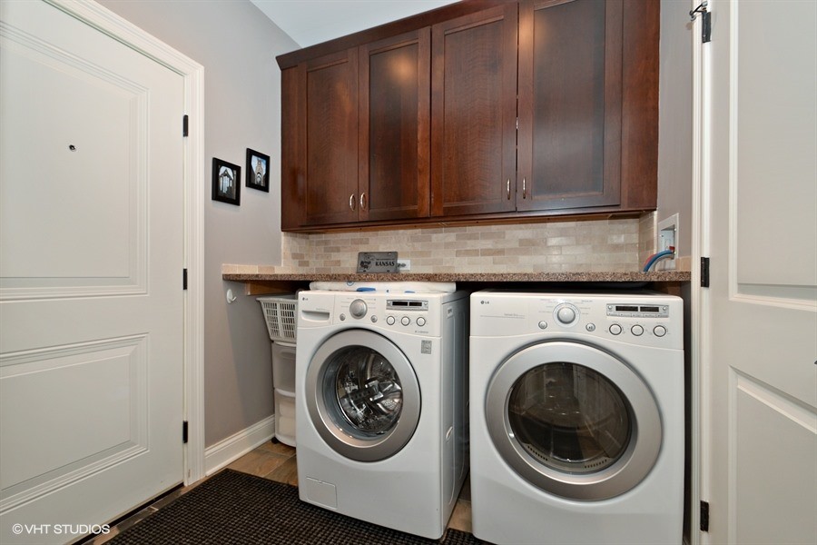 Mid-sized transitional single-wall slate floor dedicated laundry room photo in Chicago with shaker cabinets, dark wood cabinets, granite countertops, gray walls and a side-by-side washer/dryer