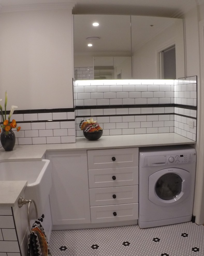 Medium sized traditional utility room in Melbourne with shaker cabinets, white cabinets and white walls.