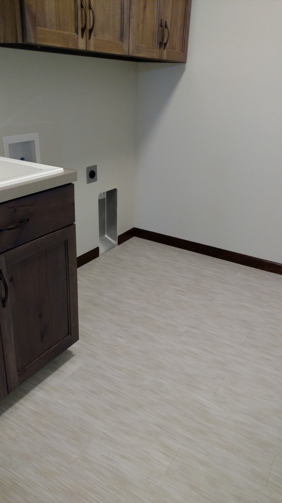 Inspiration for a mid-sized eclectic vinyl floor laundry room remodel in Seattle with an utility sink, shaker cabinets, medium tone wood cabinets, laminate countertops, gray walls and a side-by-side washer/dryer