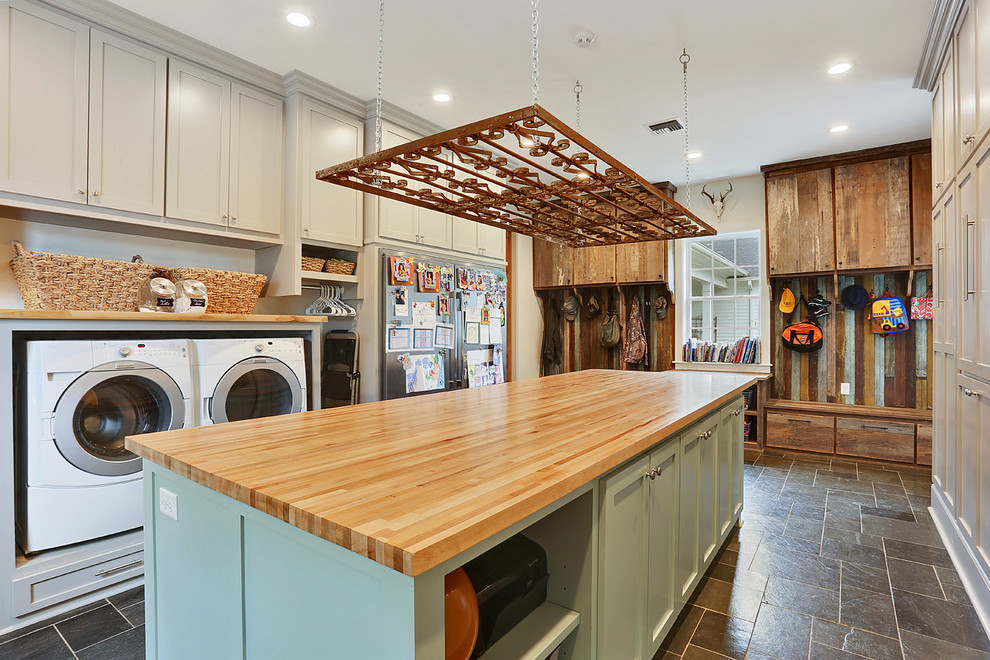 Example of a southwest laundry room design in New Orleans with shaker cabinets, gray cabinets, wood countertops, gray walls, a side-by-side washer/dryer and beige countertops