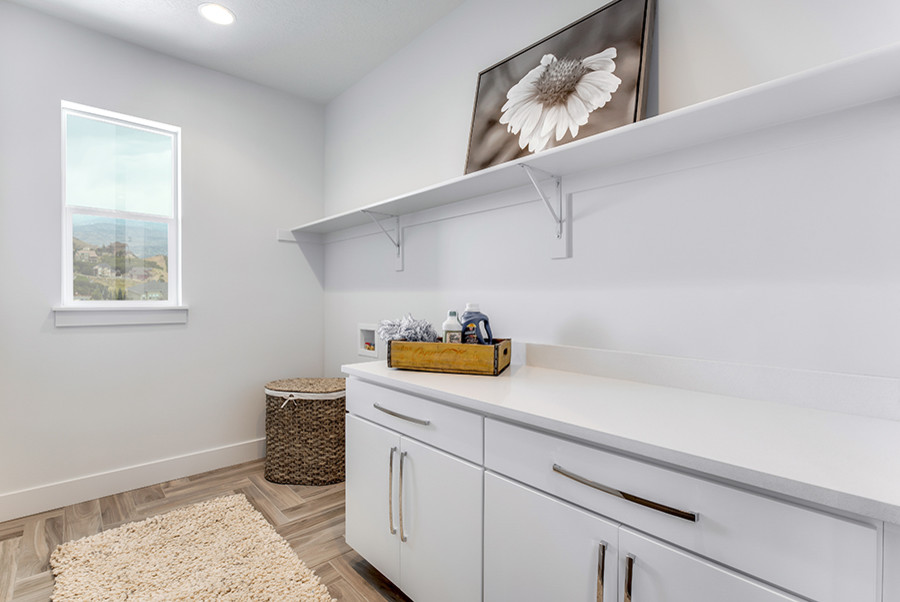 Zweizeilige, Mittelgroße Klassische Waschküche mit flächenbündigen Schrankfronten, weißen Schränken, Onyx-Arbeitsplatte, weißer Wandfarbe, Keramikboden, Waschmaschine und Trockner nebeneinander und braunem Boden in Salt Lake City