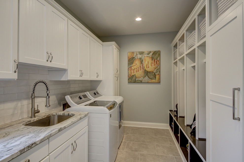 Large classic galley utility room in Dallas with a submerged sink, shaker cabinets, white cabinets, granite worktops, grey walls, porcelain flooring, a side by side washer and dryer, grey floors and grey worktops.