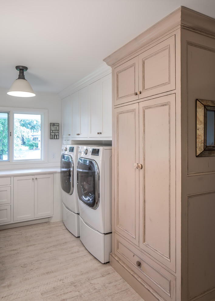 Inspiration for a mid-sized eclectic l-shaped vinyl floor utility room remodel in Minneapolis with flat-panel cabinets and a side-by-side washer/dryer
