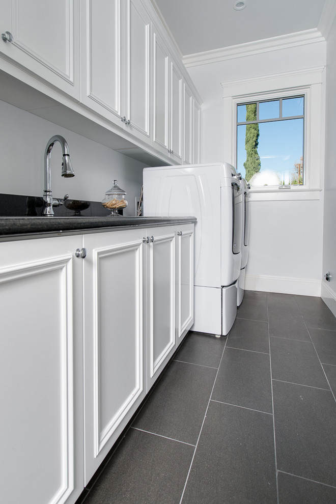 Dedicated laundry room - large coastal single-wall ceramic tile dedicated laundry room idea in Los Angeles with an undermount sink, shaker cabinets, white cabinets, marble countertops, blue walls and a side-by-side washer/dryer