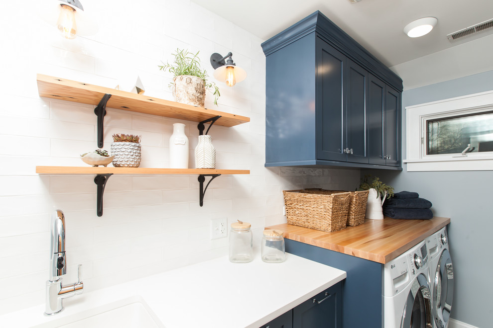 Inspiration for a mid-sized modern single-wall concrete floor and blue floor dedicated laundry room remodel in Chicago with an undermount sink, shaker cabinets, blue cabinets, quartz countertops, blue walls, a side-by-side washer/dryer and white countertops