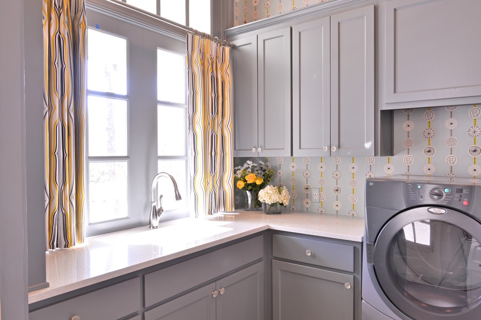 Large transitional l-shaped laundry room photo in Dallas with an undermount sink, shaker cabinets, gray cabinets, quartz countertops, blue walls and a side-by-side washer/dryer