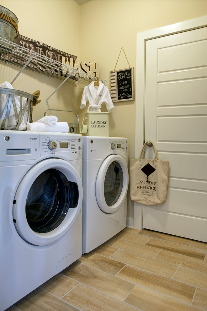 Small transitional single-wall ceramic tile dedicated laundry room photo in Other with beige walls and a side-by-side washer/dryer