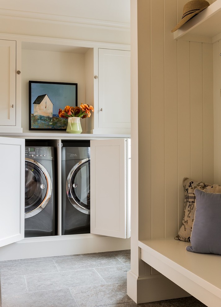 Design ideas for a medium sized traditional utility room in Boston with shaker cabinets, white cabinets, engineered stone countertops, white walls, ceramic flooring and a side by side washer and dryer.