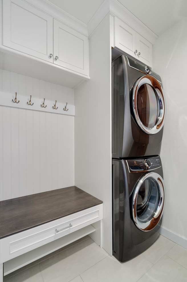 Inspiration for a small cottage single-wall utility room remodel in Denver with a stacked washer/dryer