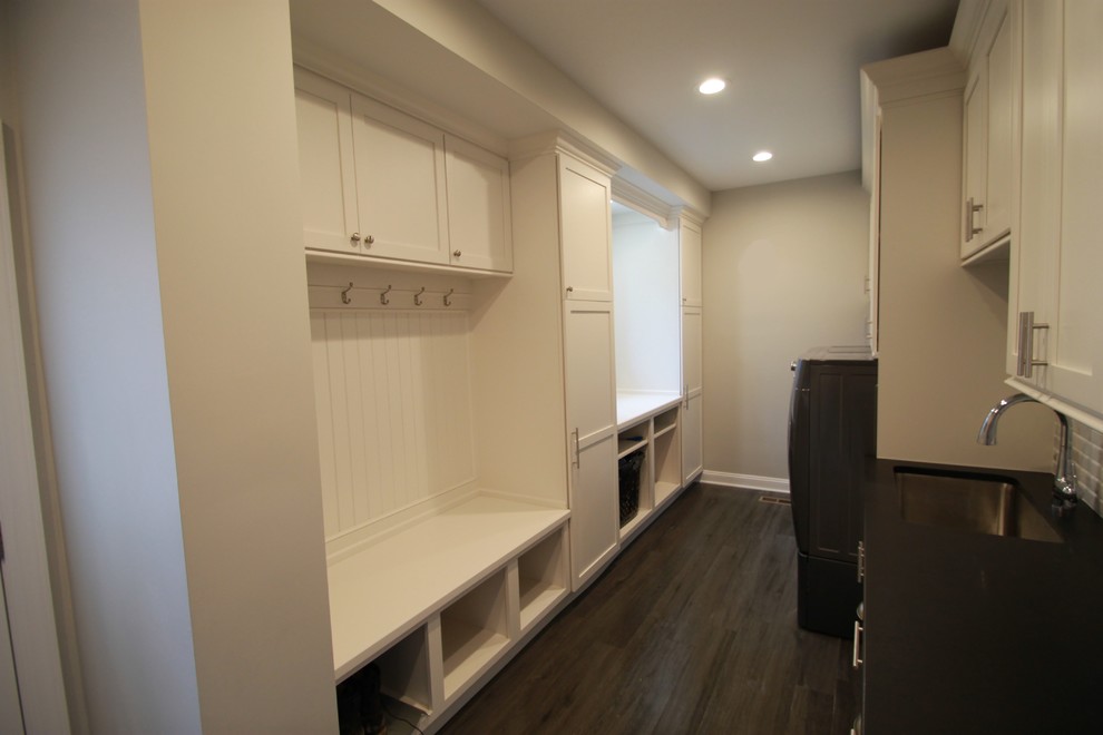 Example of a large transitional galley porcelain tile utility room design in New York with an undermount sink, shaker cabinets, white cabinets, quartzite countertops, gray walls and a side-by-side washer/dryer