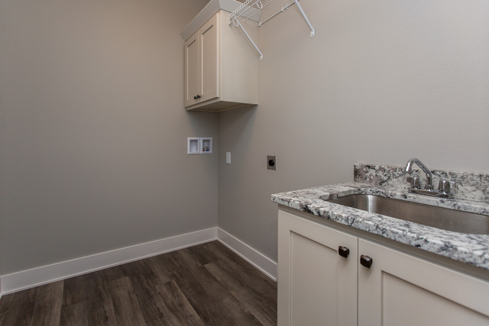 This is an example of a farmhouse single-wall utility room in Other with a submerged sink, shaker cabinets, white cabinets, granite worktops, grey walls, vinyl flooring, a side by side washer and dryer, grey floors and white worktops.