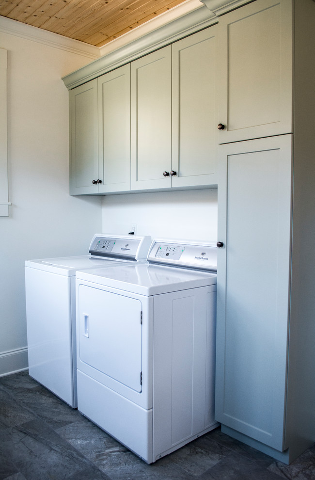 Inspiration for a medium sized country galley separated utility room in Other with a submerged sink, shaker cabinets, green cabinets, engineered stone countertops, beige walls, porcelain flooring, a side by side washer and dryer and grey floors.
