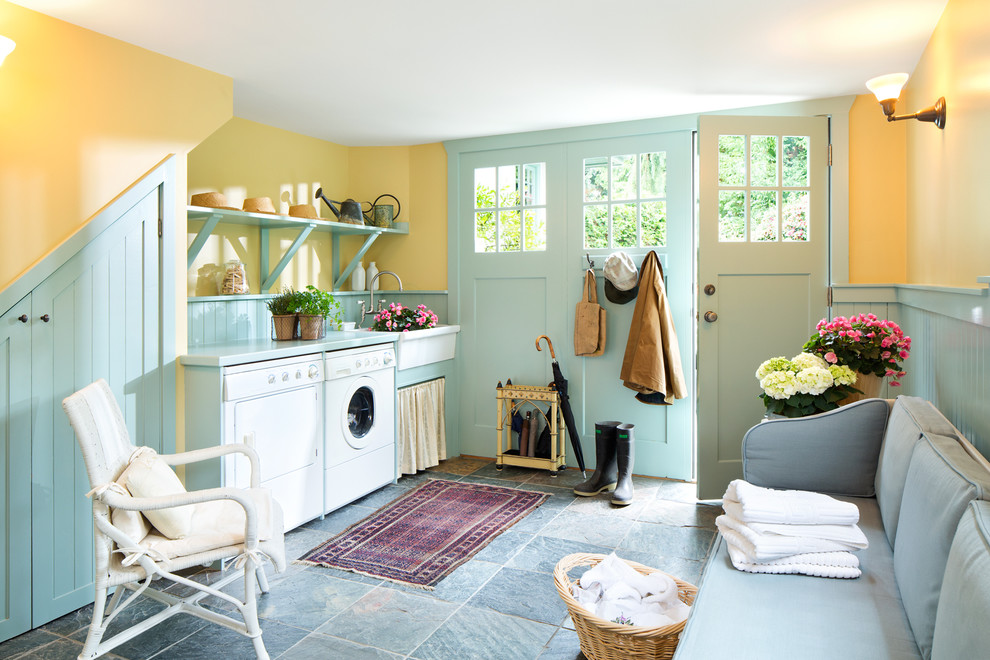 Inspiration for a farmhouse utility room remodel in Other with a farmhouse sink, open cabinets, yellow walls and a side-by-side washer/dryer