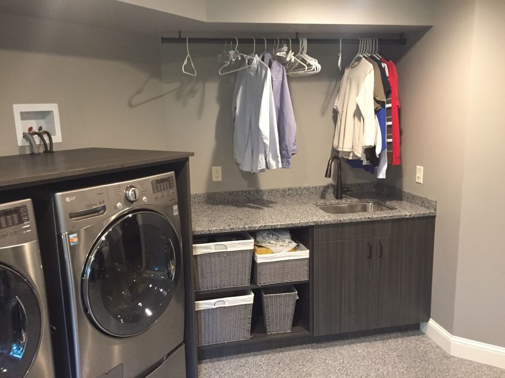Large trendy single-wall utility room photo in Minneapolis with an undermount sink, flat-panel cabinets, dark wood cabinets, beige walls and a side-by-side washer/dryer