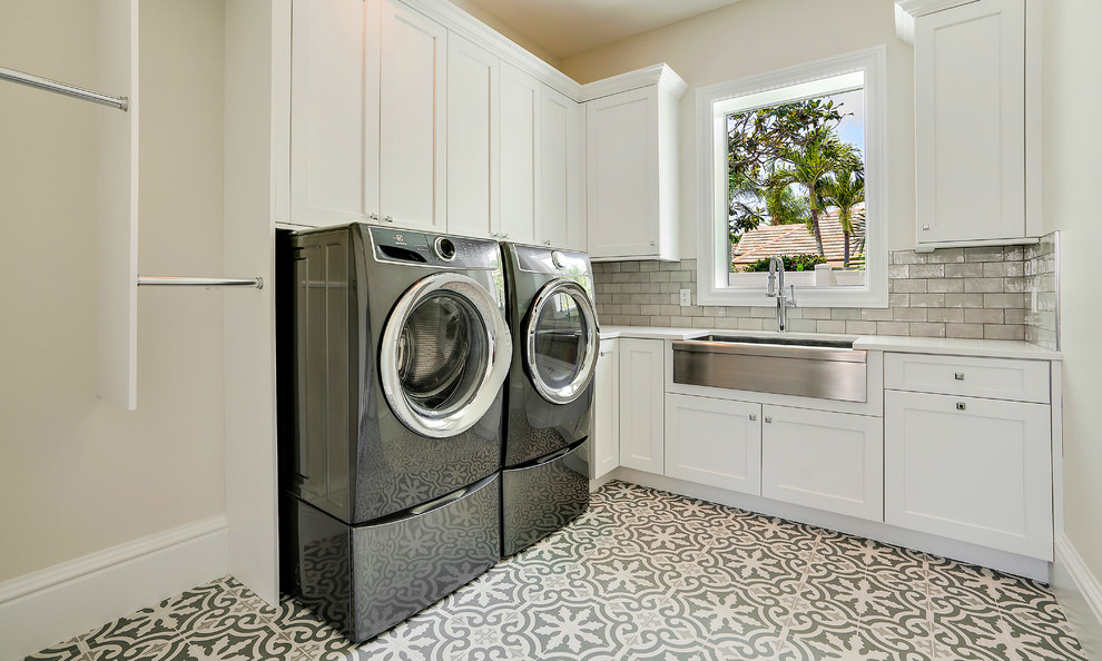 Large tuscan l-shaped porcelain tile and multicolored floor dedicated laundry room photo in Miami with a farmhouse sink, white cabinets, quartz countertops, beige walls, a side-by-side washer/dryer, white countertops and shaker cabinets