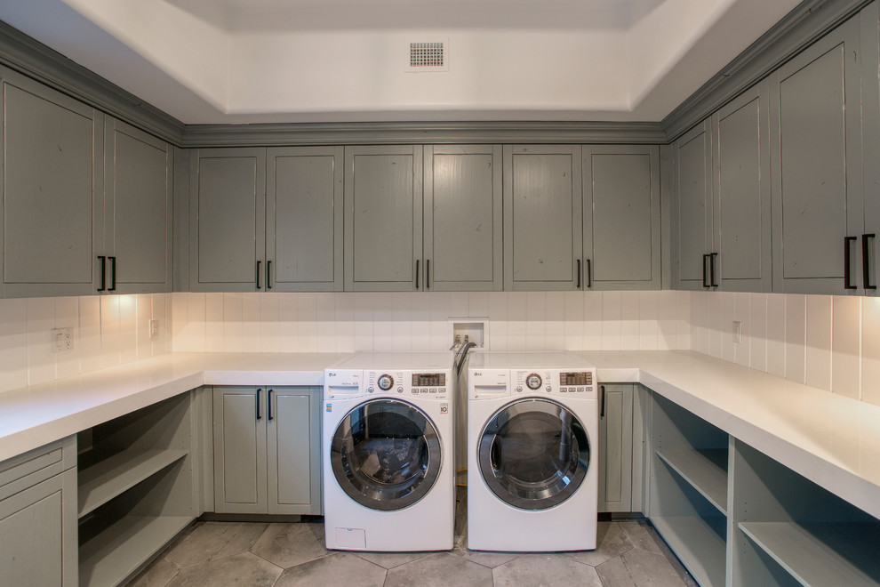 Design ideas for a large classic u-shaped utility room in Phoenix with raised-panel cabinets, grey cabinets, engineered stone countertops, white walls, ceramic flooring, a side by side washer and dryer, grey floors and white worktops.