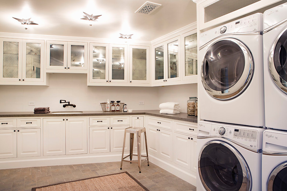 Inspiration for a huge coastal l-shaped concrete floor and brown floor dedicated laundry room remodel in San Francisco with an undermount sink, raised-panel cabinets, white cabinets, quartz countertops, white walls and a side-by-side washer/dryer