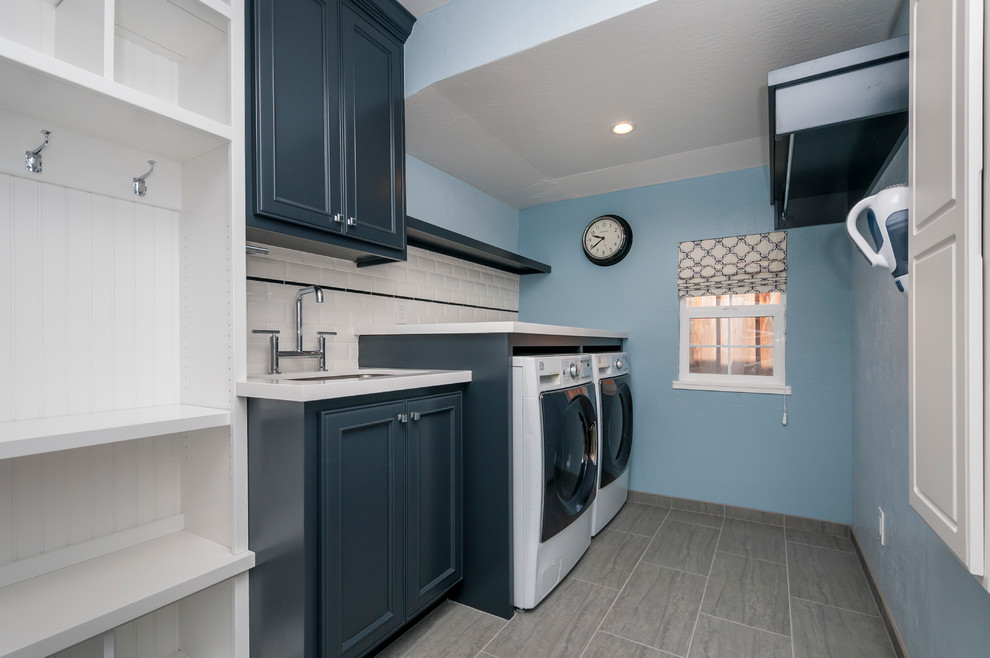 Example of a mid-sized transitional single-wall porcelain tile utility room design in San Francisco with an undermount sink, recessed-panel cabinets, quartz countertops, blue walls, a side-by-side washer/dryer and blue cabinets