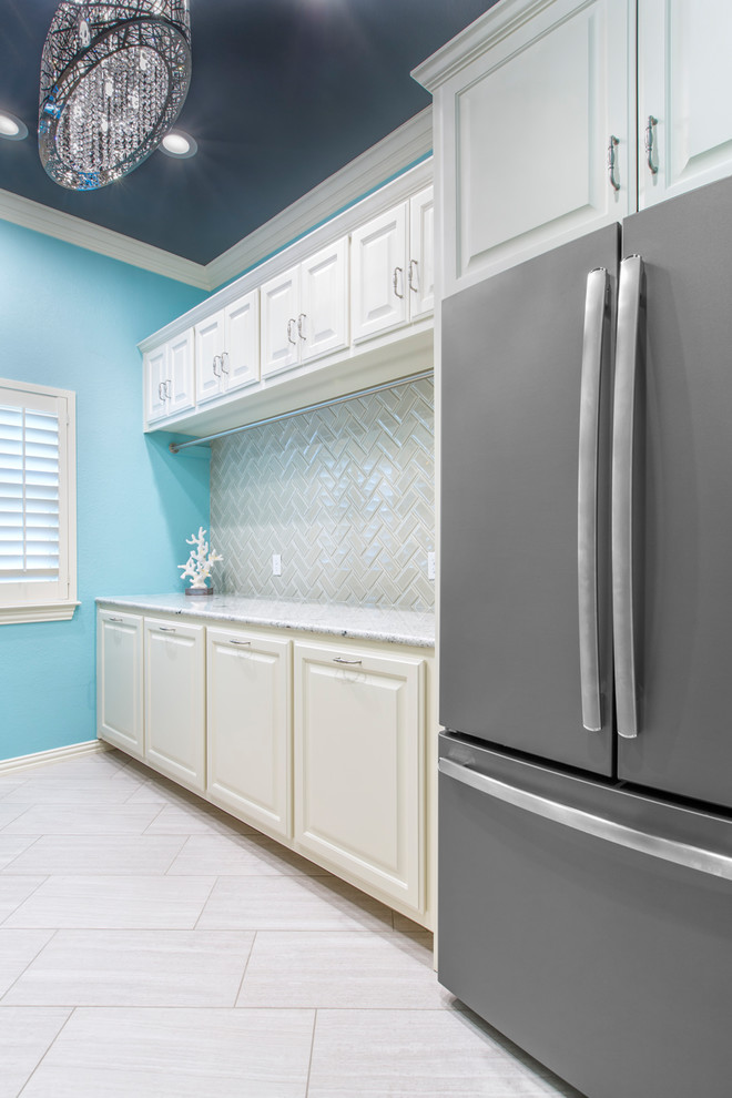 Inspiration for a large modern galley ceramic tile and beige floor dedicated laundry room remodel in Other with an undermount sink, raised-panel cabinets, white cabinets, granite countertops, blue walls and a stacked washer/dryer