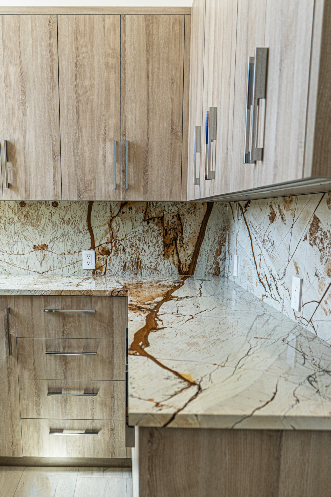 This is an example of an utility room in Miami with granite worktops and granite splashback.