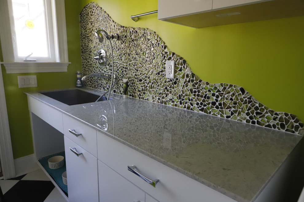 Inspiration for a large contemporary single-wall vinyl floor and multicolored floor utility room remodel in Wilmington with an utility sink, flat-panel cabinets, white cabinets, limestone countertops, green walls, a side-by-side washer/dryer and multicolored countertops
