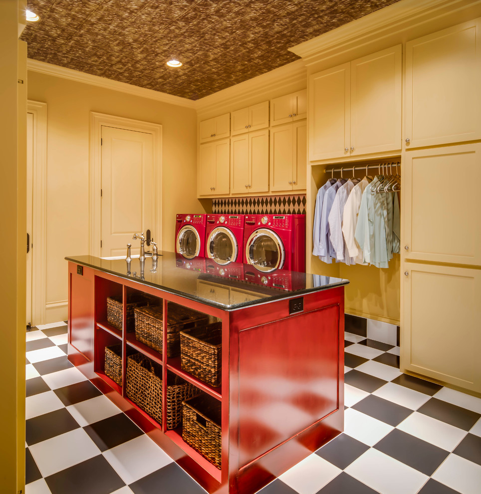 This is an example of a large traditional separated utility room in Austin with shaker cabinets, yellow cabinets, granite worktops, yellow walls, ceramic flooring, a side by side washer and dryer and a belfast sink.
