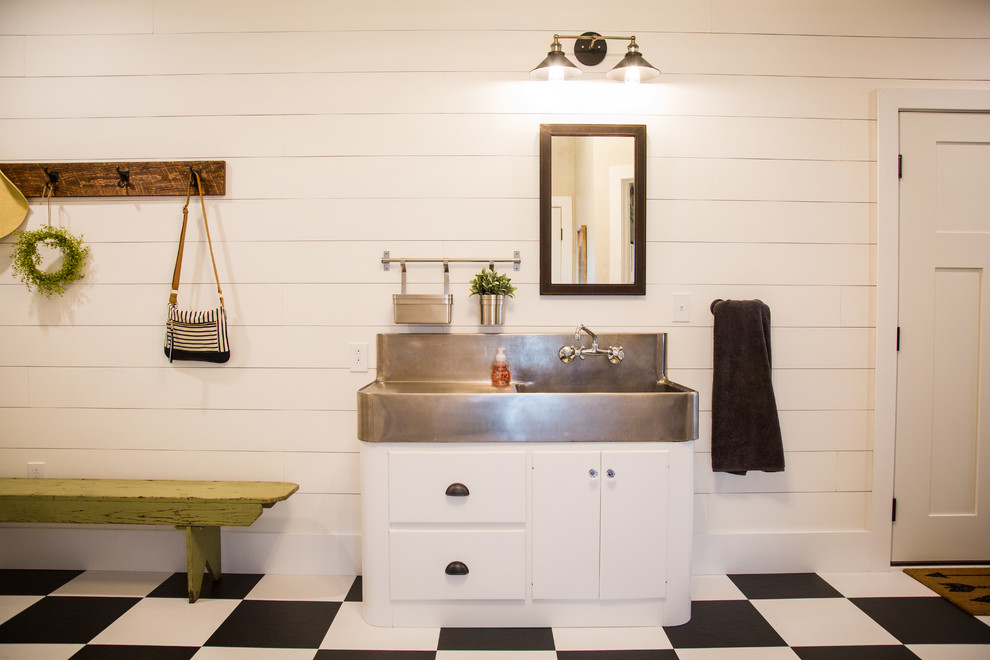 Inspiration for a small country single-wall vinyl floor and multicolored floor dedicated laundry room remodel in Other with a double-bowl sink, flat-panel cabinets, white cabinets, stainless steel countertops, beige walls and a side-by-side washer/dryer
