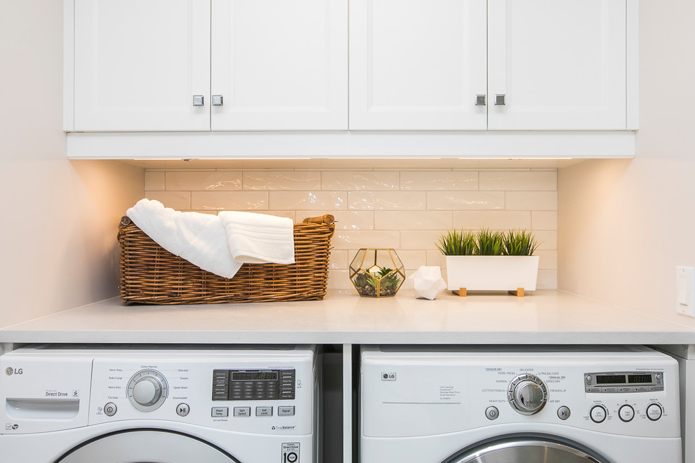 Photo of a small classic single-wall utility room in Ottawa with shaker cabinets, white cabinets, engineered stone countertops, white walls, porcelain flooring, a side by side washer and dryer, white floors and white worktops.