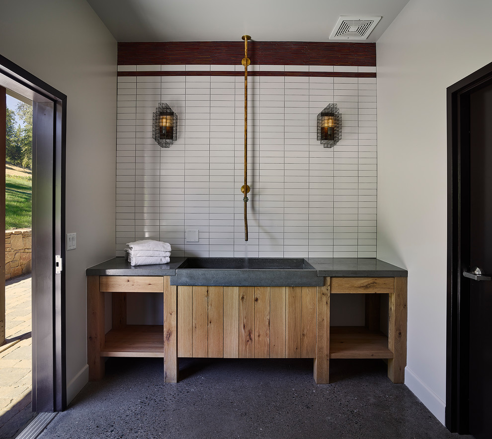 Country utility room in San Francisco with an integrated sink, open cabinets, light wood cabinets, concrete worktops, white walls and grey floors.