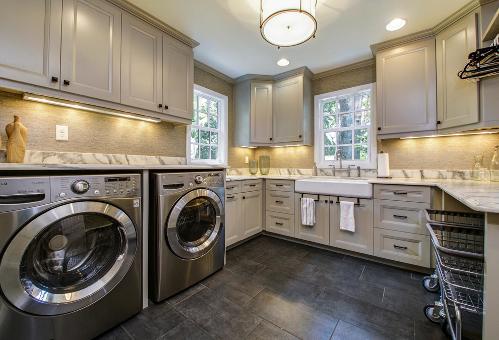 Diseño de cuarto de lavado en U de estilo de casa de campo con fregadero de un seno, puertas de armario grises y lavadora y secadora juntas