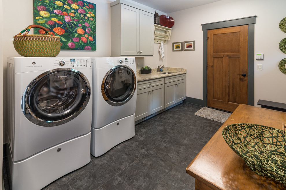 Photo of a classic single-wall utility room in Other with a submerged sink, shaker cabinets, grey cabinets, granite worktops, white walls, vinyl flooring and a side by side washer and dryer.