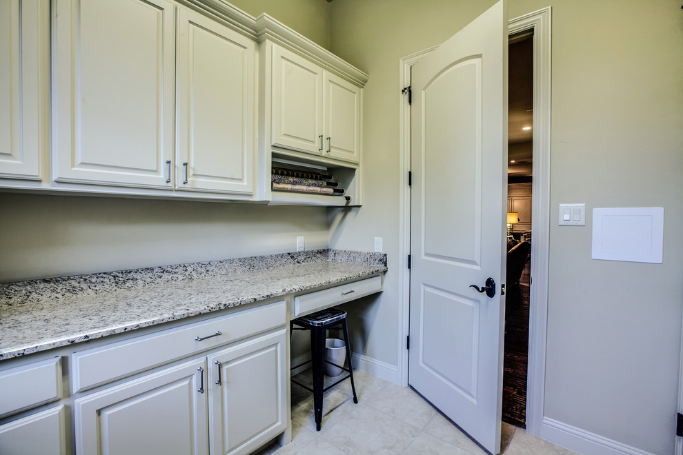 Medium sized traditional u-shaped utility room in Dallas with a submerged sink, raised-panel cabinets, beige cabinets, granite worktops, beige walls, travertine flooring and a side by side washer and dryer.