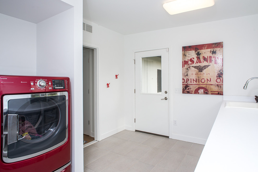 Inspiration for a contemporary laundry room remodel in Detroit with flat-panel cabinets, white cabinets, white walls and a side-by-side washer/dryer