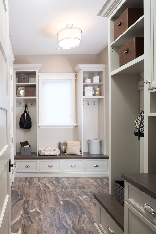 Mid-sized elegant u-shaped gray floor utility room photo in Toronto with beaded inset cabinets, gray cabinets and gray walls