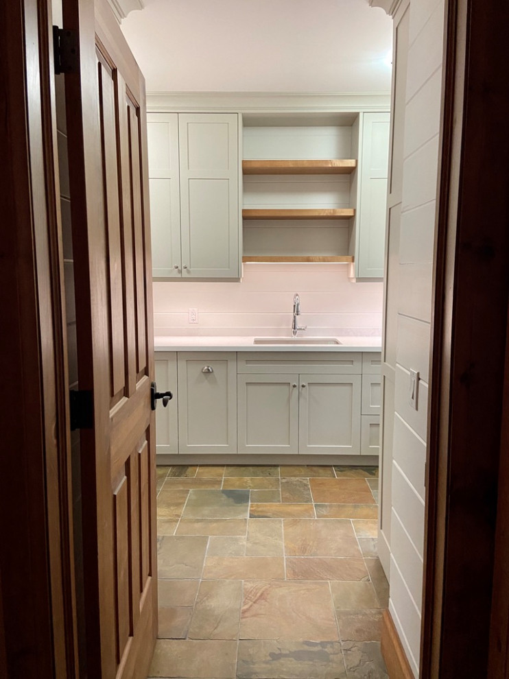 Example of a mid-sized transitional galley slate floor, multicolored floor and shiplap wall utility room design in Toronto with an undermount sink, shaker cabinets, gray cabinets, quartz countertops, white backsplash, quartz backsplash, white walls, a side-by-side washer/dryer and white countertops